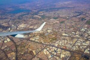 Flying airplane over Mexico Clouds Sky Volcanoes Mountains City desert. photo