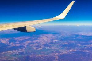 Flying airplane over Mexico Clouds Sky Volcanoes Mountains City desert. photo