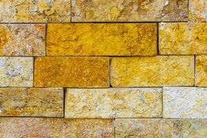 Yellow orange bricks of a wall texture pattern Mexico. photo