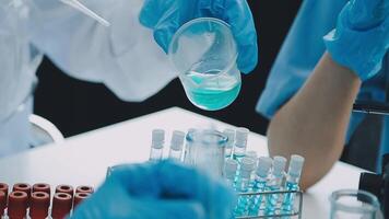 Health care researchers working in life science laboratory. Young female research scientist and senior male supervisor preparing and analyzing microscope slides in research lab. video