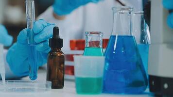 Health care researchers working in life science laboratory. Young female research scientist and senior male supervisor preparing and analyzing microscope slides in research lab. video