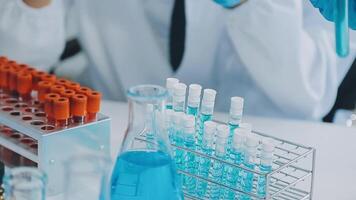 Health care researchers working in life science laboratory. Young female research scientist and senior male supervisor preparing and analyzing microscope slides in research lab. video