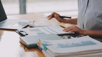 Businesswoman using phone, taking notes at office desk video