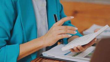 Businesswoman using phone, taking notes at office desk video