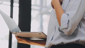 Businesswoman using phone, taking notes at office desk video