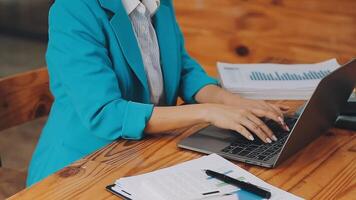 Businesswoman using phone, taking notes at office desk video