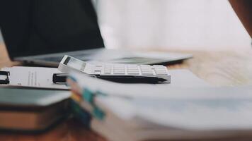 Businesswoman using phone, taking notes at office desk video