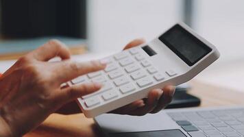 Businesswoman using phone, taking notes at office desk video