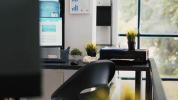 Empty financial department office used for budgeting, forecasting, and financial analysis purposes. Company workspace with nobody in and business figures on computer monitors left open video