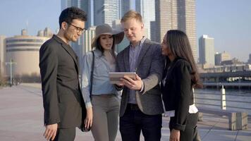 Group of Diverse Multi Ethnic Mixed Race People Watching Video On Tablet