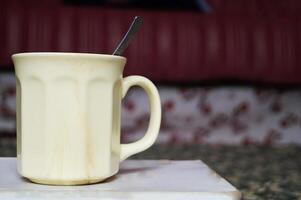 Cream-Colored Mug Filled With Beverage on a Marble Surface in a Cozy Room photo