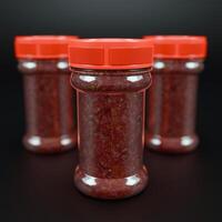 Chilly sauce or ketchup in plastic bottle made of red hot chili peppers. Indonesian chili spice. Mockup for logo or design photo