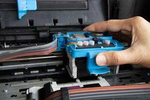 Technician repairing printer, fixing printer head photo