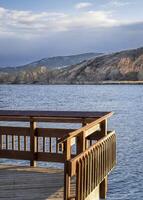 Fishing pier on a lake at Colorado foothills - Watson Lake State Wilderness Area in winter windy conditions photo