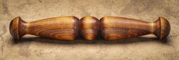 Wooden Tai Chi ruler, a  traditional Chinese exercise tool, on textured bark paper photo