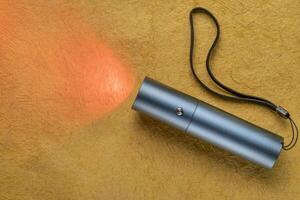 red and infrared light therapy - a small torch light for local treatment and pain relief photo