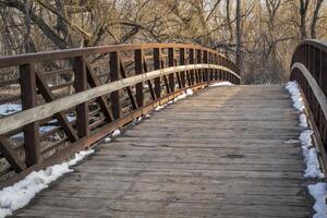 bike trail and footbridge over a river in winter or early spring  - Cache la Poudre River in Fort Collins, Colorado photo