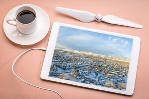 cold winter sunrise over residential area of Fort Collins and Rocky Mountains in northern Colorado, aerial image displayed on a digital tablet photo