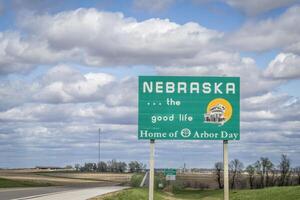 Nebraska, el bueno vida, hogar de cenador día - borde del camino Bienvenido firmar a estado frontera con Kansas, primavera paisaje foto