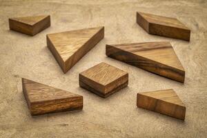 seven tangram wooden pieces, a traditional Chinese puzzle game, texture bark paper background photo