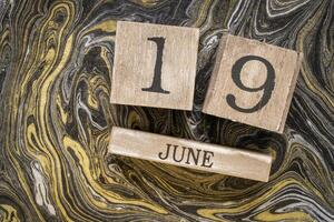 Juneteenth, June 19, in a desktop wooden calendar, Freedom, Jubilee, Liberation, and Emancipation Day, is a holiday celebrating the emancipation of those who had been enslaved in the US. photo