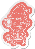 funny cartoon distressed sticker of a monkey with christmas present wearing santa hat png
