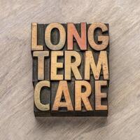 long term care word abstract in vintage letterpress wood type, health and aging concept photo