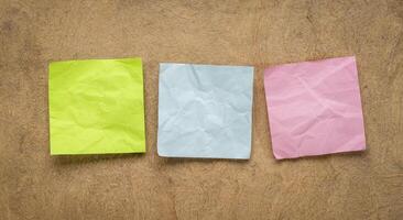 colorful blank reminder notes on textured bark paper photo