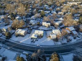 winter morning over a residential area of Fort Collins in northern Colorado with fresh snow, aerial view photo