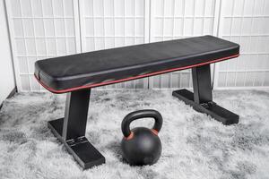 heavy iron kettlebell and exercise bench in a home gym, fitness concept photo