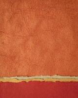 abstract landscape in red and orange - collection of Huun papers handmade in Mexico, vertical background photo