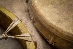 two handmade, native American style, shaman frame drums covered by goat skin photo