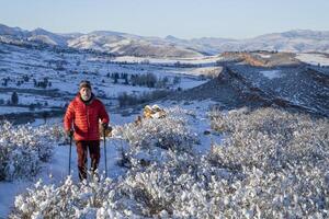 senior hiker in winter scenery of Rocky Mountains foothills in northern Colorado, Lory State Park photo