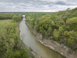 aerial view of Missouri River valley above Jefferson City, MO, with Katy Trail crossing Cedar Creek, cloudy spring afternoon photo