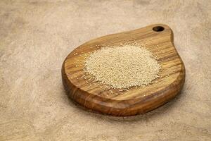 gluten free amaranth grain on a mini wooden cutting board photo