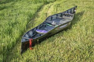racing tandem canoe, carbon fiber construction, on a grassy area photo