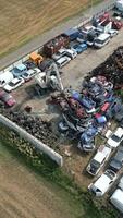 Crane moving scrap metal cars in a junkyard. video