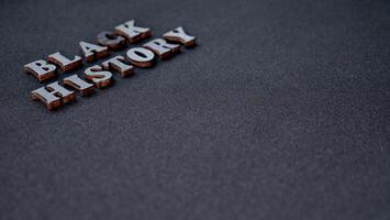 Inscription text Black History Month on dark grey isolated background close up. Celebrating the African American Conceptual Holiday for Equality photo