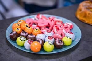 Delicious sweets and candies on plate. Candy bar decoration setup with delicious cakes and sweets. Candy bar for party. photo