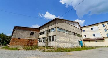 Abandoned building in the countryside on a sunny day. Rustic storehouse. photo