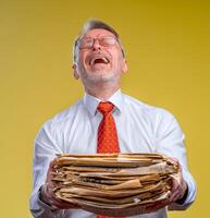 Files in hands of a surprised businessman or manager isolated on yellow background. photo