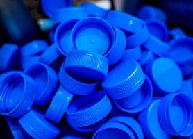 Blue plastic cups for bottles. Cropped photo. Equipment at the dairy plant. photo