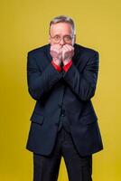 Emotional man in a business suit holds hands near the face. Excited. Human emotions photo