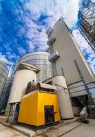 Tanks and agricultural silos of grain elevator storage. Loading facility building exterior. View from below photo