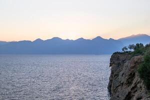 Picturesque mountain range juts into the tranquil blue lake below photo