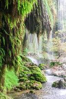 Kursunlu waterfall with clear water in the lake. View of Kursunlu Waterfall in Antalya, flowing from high mountain. photo