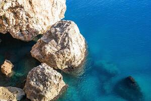 Tranquil beach scene with azure waters and unique rock formations under a bright sun photo