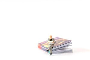 World Book Day concept, Miniature people elderly guy reading a book alone photo