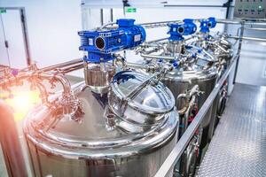 Dairy factory with milk pasteurization tank and pipes photo