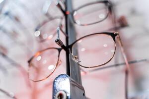 Various spectacles on display in optical store. Close-up photo